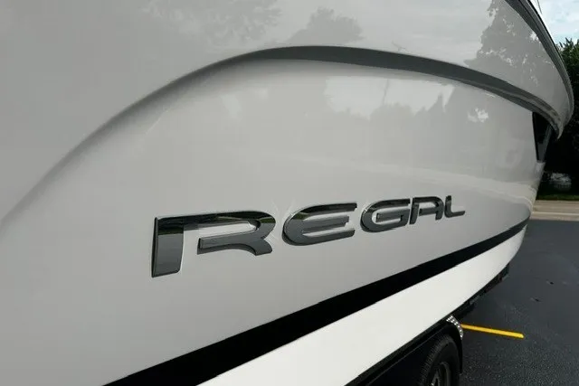 Slide: The Image of 2027 Regal 3300 boat with sleek design and prominent logo on the side. - 4