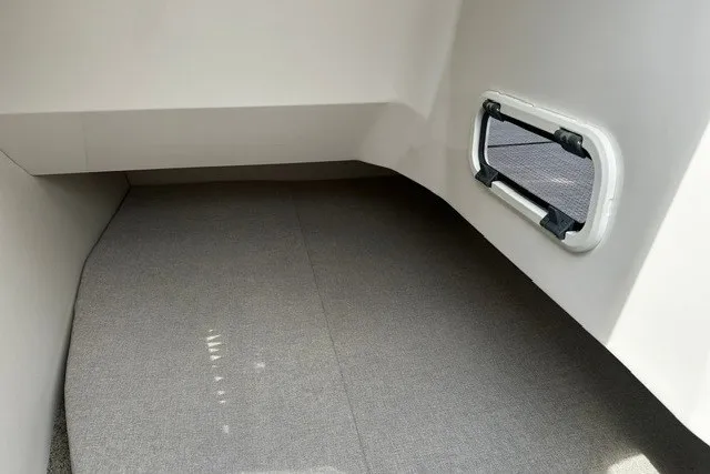 Slide: The Image of Interior cabin of 2027 Regal 3300 boat with carpeted flooring and window. - 30