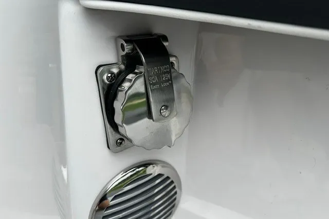 Slide: The Image of Close-up of a 2027 Regal 3300 boat's electrical outlet and speaker. - 36