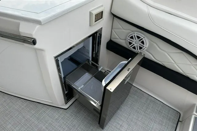 Slide: The Image of Luxury interior of 2027 Regal 3300 boat with open drawer and speaker detail. - 20