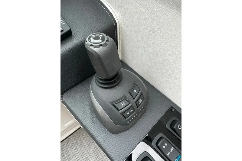 Slide: The Image of Joystick control panel of 2027 Regal 3300 boat, featuring multiple buttons. - 13