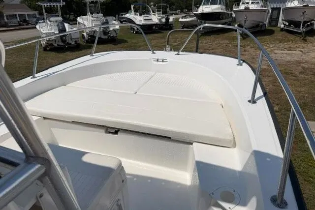 Slide: The Image of 2013 Boston Whaler 21 Montauk boat deck with seating, displayed outdoors. - 7
