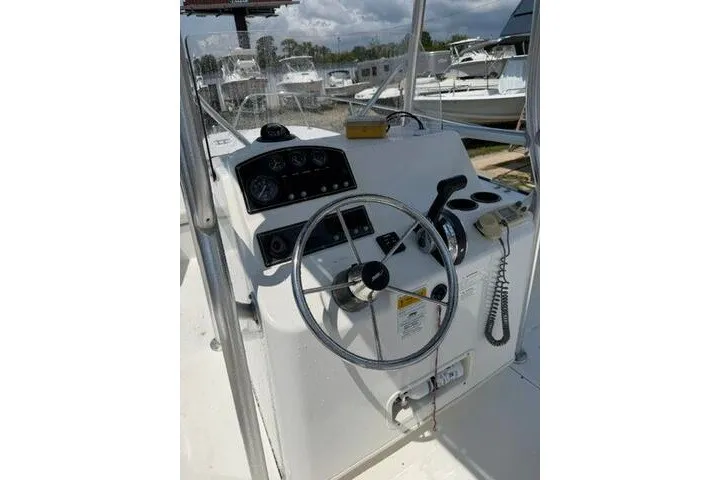Slide: The Image of 2013 Boston Whaler 21 Montauk boat console with steering wheel and controls. - 24