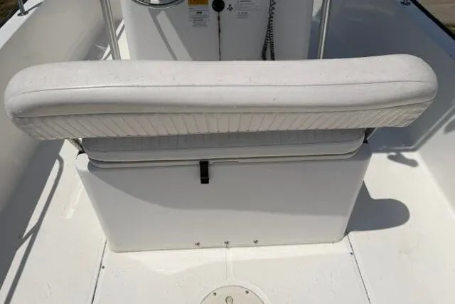 Slide: The Image of 2013 Boston Whaler 21 Montauk boat interior with white cushioned seating. - 20