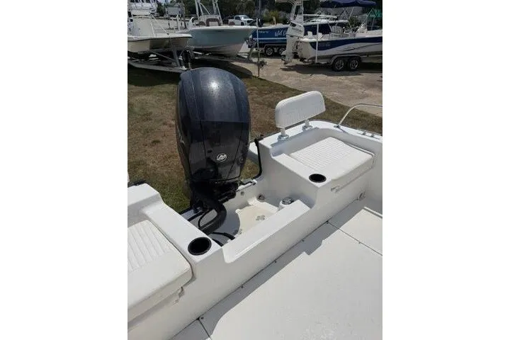 Slide: The Image of 2013 Boston Whaler 21 Montauk boat interior with motor and seating. - 17
