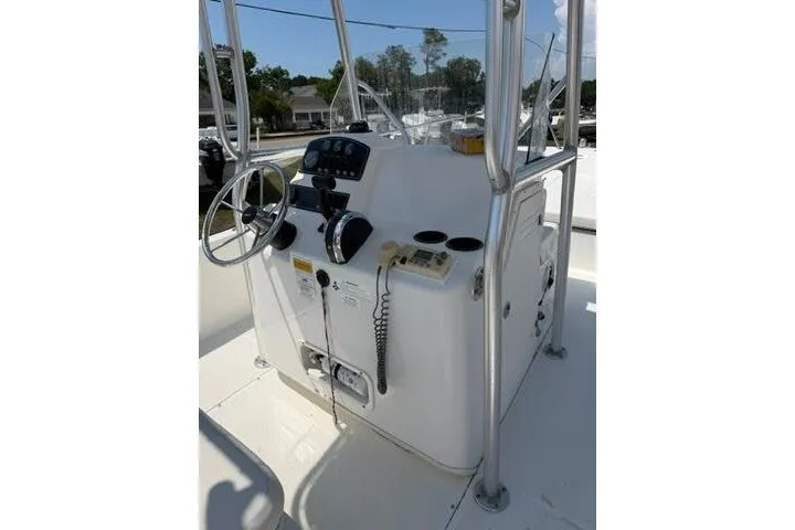 Slide: The Image of 2013 Boston Whaler 21 Montauk boat console with steering wheel and controls. - 27