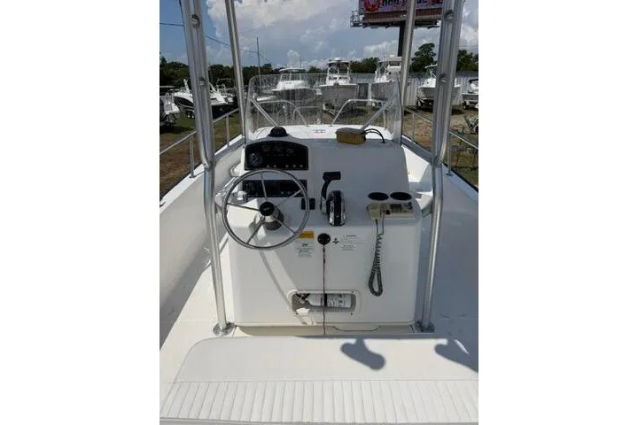 Slide: The Image of 2013 Boston Whaler 21 Montauk boat console with steering wheel and controls. - 18