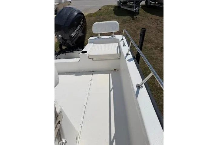 Slide: The Image of 2013 Boston Whaler 21 Montauk boat deck with seating and Mercury outboard motor. - 14