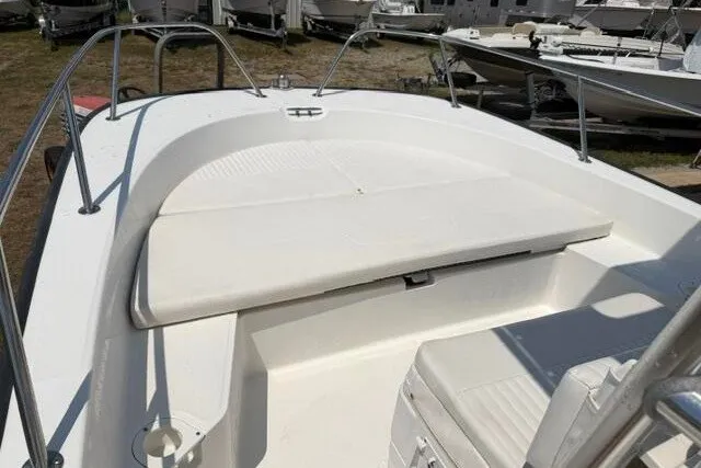Slide: The Image of 2013 Boston Whaler 21 Montauk boat interior with cushioned seating and railing. - 8