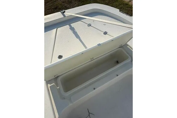 Slide: The Image of 2013 Boston Whaler 21 Montauk boat storage compartment open on deck. - 6
