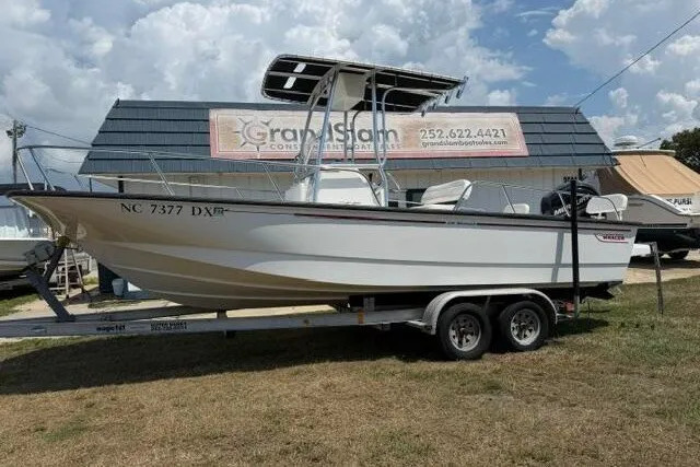 The Image of 2013 Boston Whaler 21 Montauk boat on trailer, parked outdoors near dealership. - 0