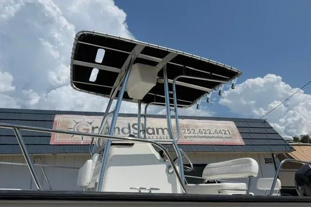 Slide: The Image of 2013 Boston Whaler 21 Montauk boat with T-top against cloudy sky backdrop. - 4