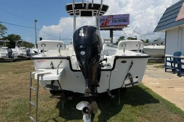 Slide: The Image of 2013 Boston Whaler 21 Montauk boat with outboard motor, displayed outdoors. - 3
