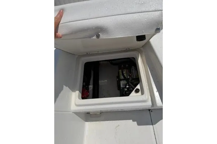 Slide: The Image of 2013 Boston Whaler 21 Montauk storage compartment with battery inside. - 28