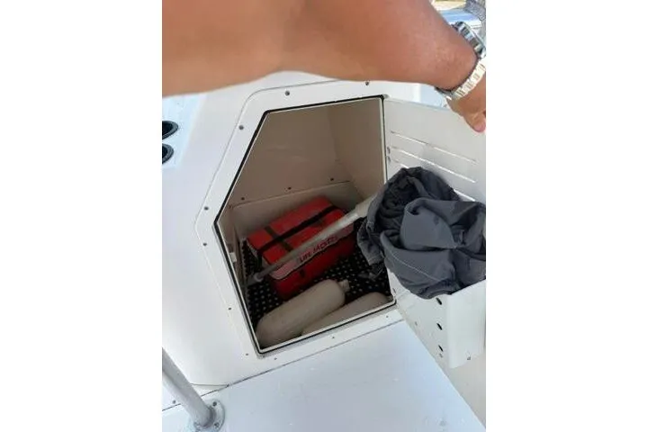 Slide: The Image of Storage compartment of a 2013 Boston Whaler 21 Montauk boat with safety gear. - 22
