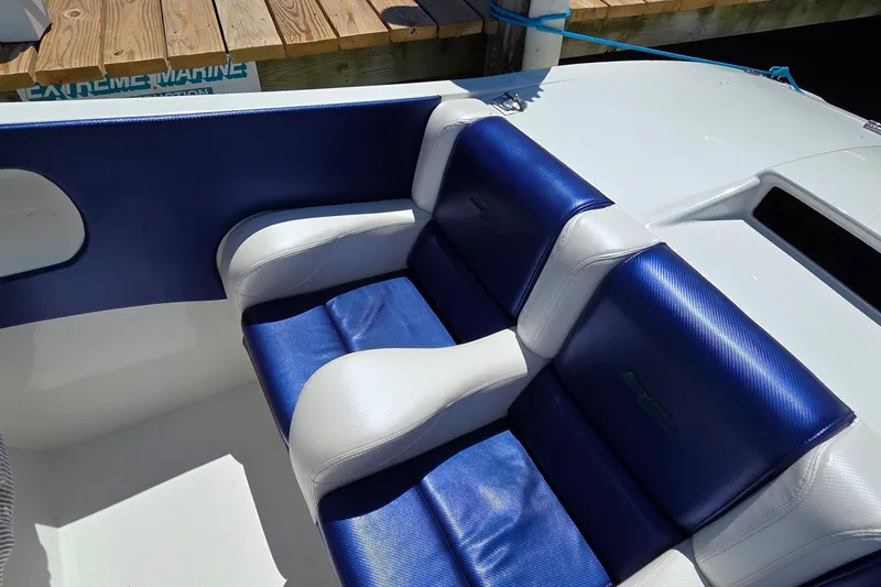 Slide: The Image of Blue and white seating on a 2021 Activator 30 boat, docked near wooden pier. - 15