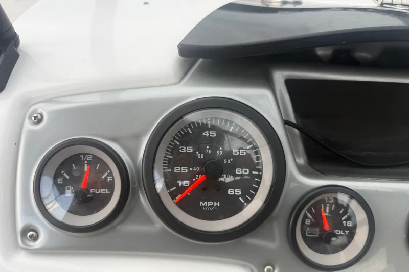 Slide: The Image of Dashboard of a 2019 Tahoe 550 TS boat showing fuel, speed, and voltage gauges. - 25