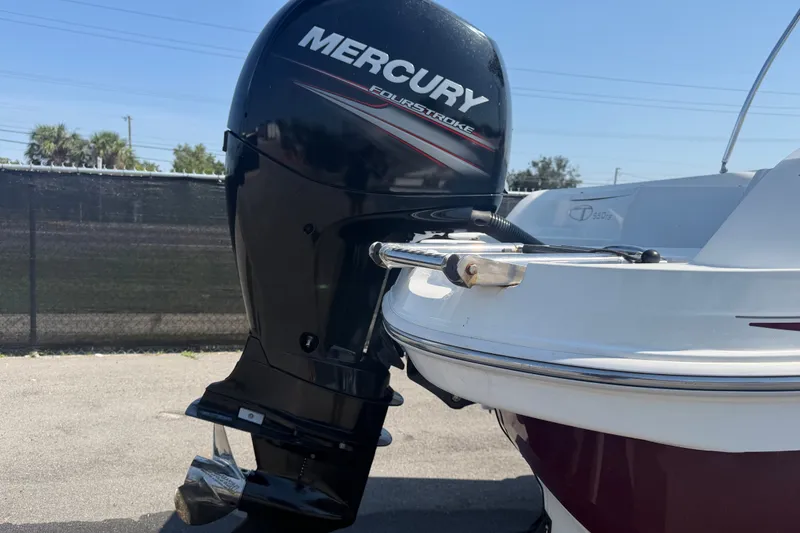 Slide: The Image of 2019 Tahoe 550 TS boat with Mercury FourStroke outboard motor, parked outdoors. - 11