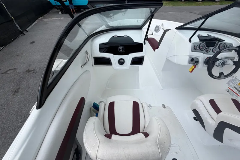 Slide: The Image of Interior of a 2019 Tahoe 550 TS boat, featuring white and maroon seating. - 19