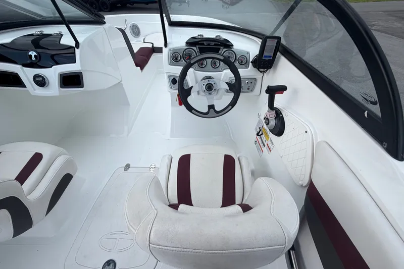 Slide: The Image of 2019 Tahoe 550 TS boat interior with steering wheel and seating. - 23
