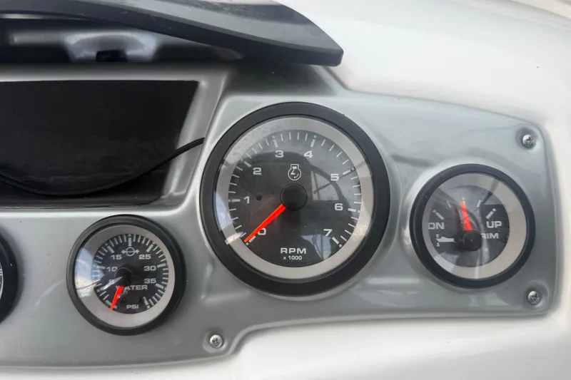 Slide: The Image of Dashboard gauges of a 2019 Tahoe 550 TS boat, displaying RPM and water pressure. - 26