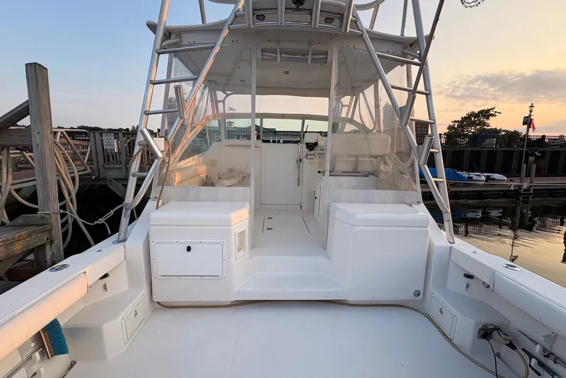 Slide: The Image of 2002 Cabo 31 Express boat docked at marina during sunset. - 5