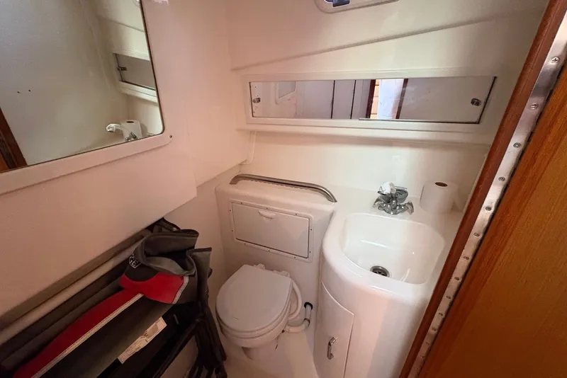 Slide: The Image of Compact bathroom in 2002 Cabo 31 Express boat with sink, toilet, and mirror. - 15