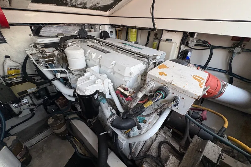 Slide: The Image of Engine room of a 2002 Cabo 31 Express boat, showcasing mechanical components and wiring. - 17