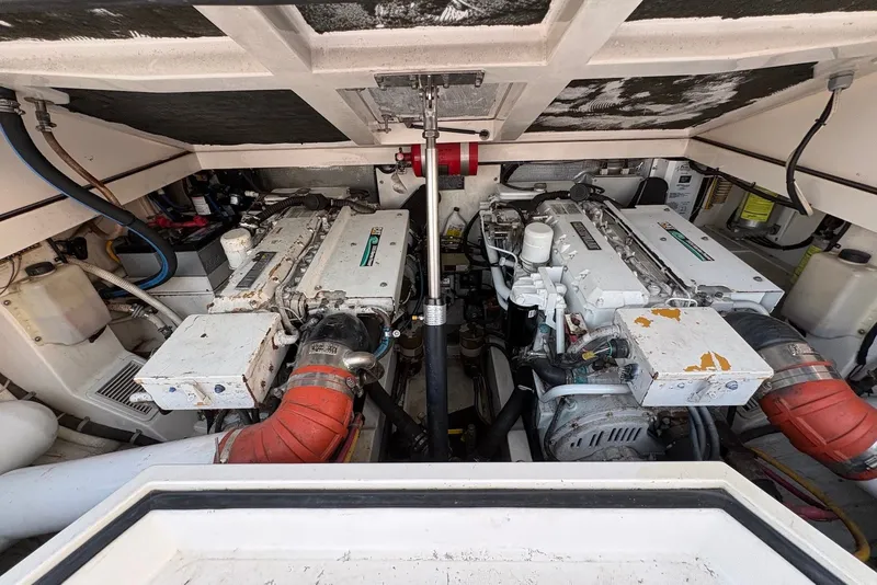 Slide: The Image of Engine room of a 2002 Cabo 31 Express boat, showcasing dual engines and mechanical components. - 16