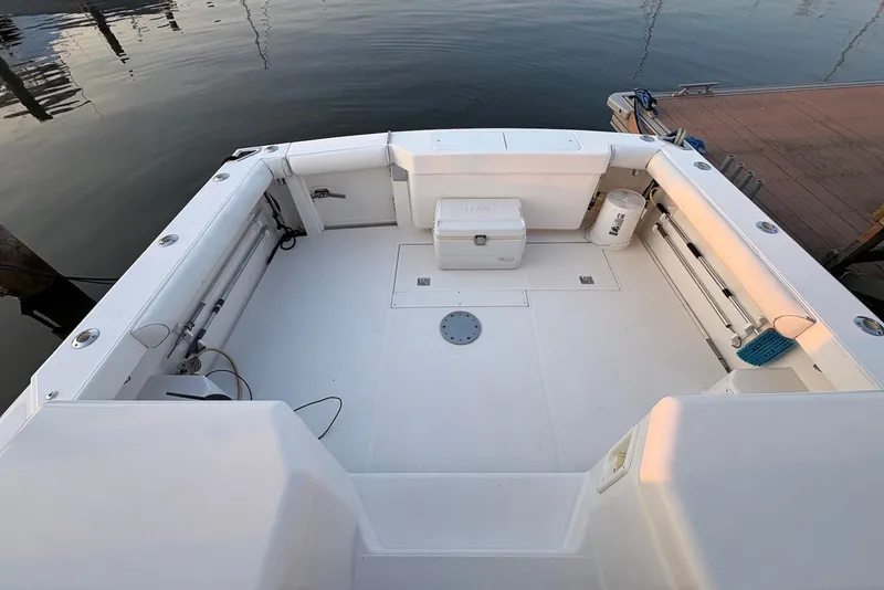 Slide: The Image of 2002 Cabo 31 Express boat deck with storage and fishing equipment. - 6