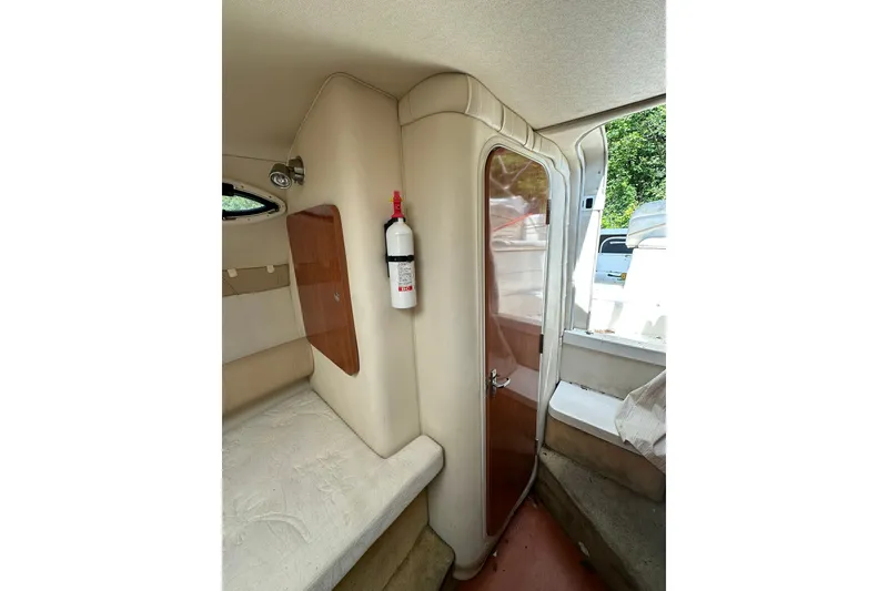 Slide: The Image of Interior of 2006 Larson Cabrio 240 boat with seating and fire extinguisher. - 11
