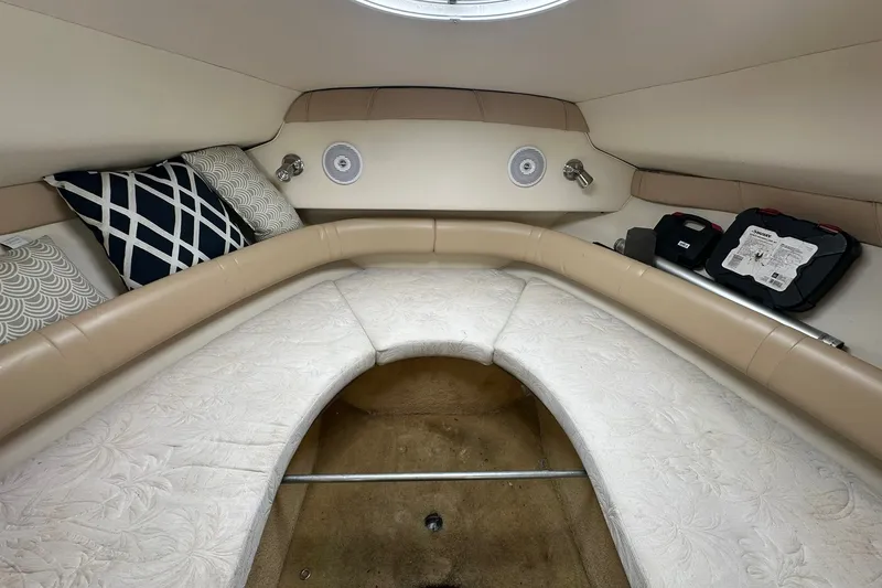 Slide: The Image of Interior cabin of a 2006 Larson Cabrio 240 boat with cushions and storage. - 10