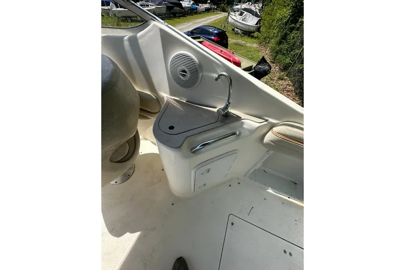 Slide: The Image of 2006 Larson Cabrio 240 boat interior with sink and speaker. - 21