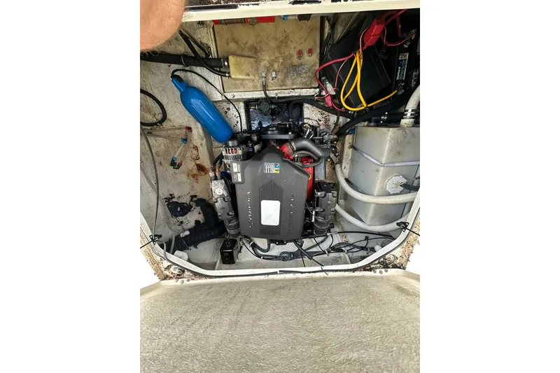Slide: The Image of Engine compartment of a 2006 Larson Cabrio 240 boat, showing various components and wiring. - 23