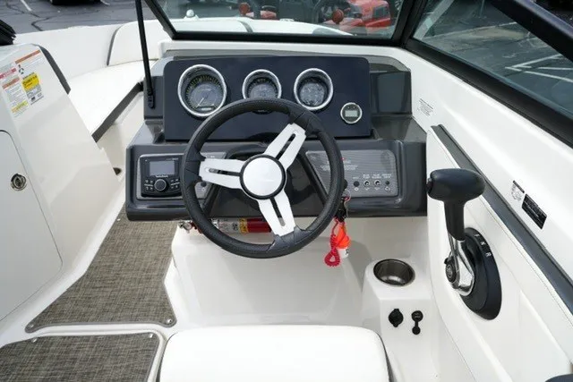 Slide: The Image of Cockpit view of 2018 Sea Ray SPX 210 boat with steering wheel and control panel. - 14