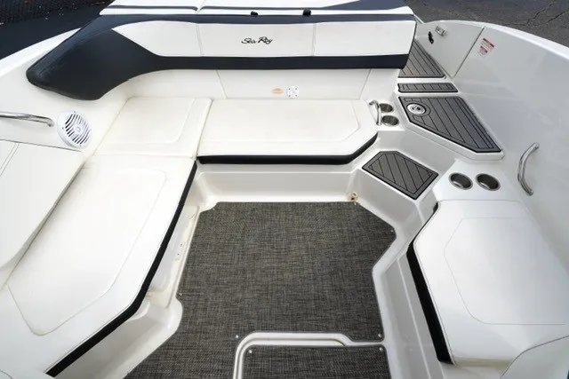 Slide: The Image of Interior seating of a 2018 Sea Ray SPX 210 boat with sleek design and cup holders. - 16