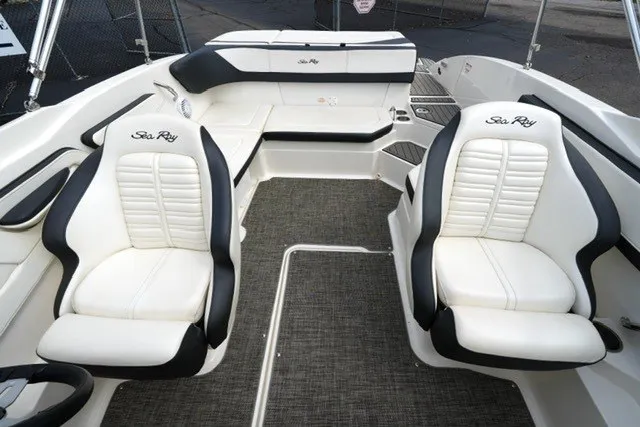 Slide: The Image of 2018 Sea Ray SPX 210 boat interior with white and black seating, spacious layout. - 15