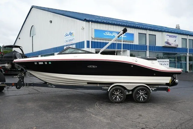 The Image of 2018 Sea Ray SPX 210 boat on trailer outside dealership. - 1