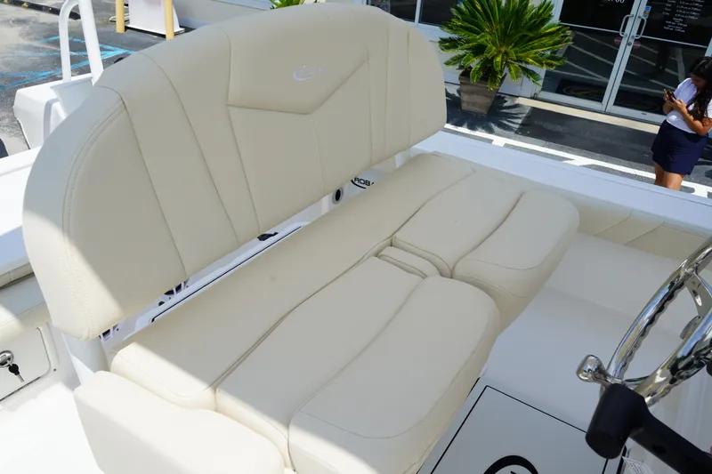 Slide: The Image of 2027 Robalo 226 Cayman boat with beige seating and steering wheel. - 16