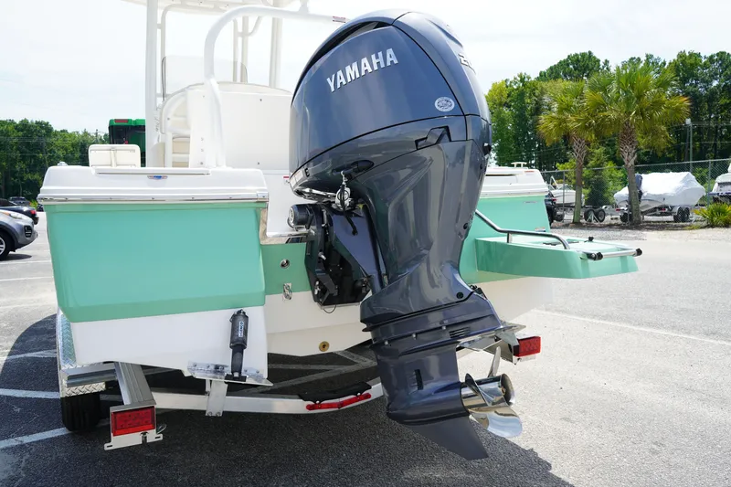 Slide: The Image of 2027 Robalo 226 Cayman boat with Yamaha outboard motor in a parking lot. - 17