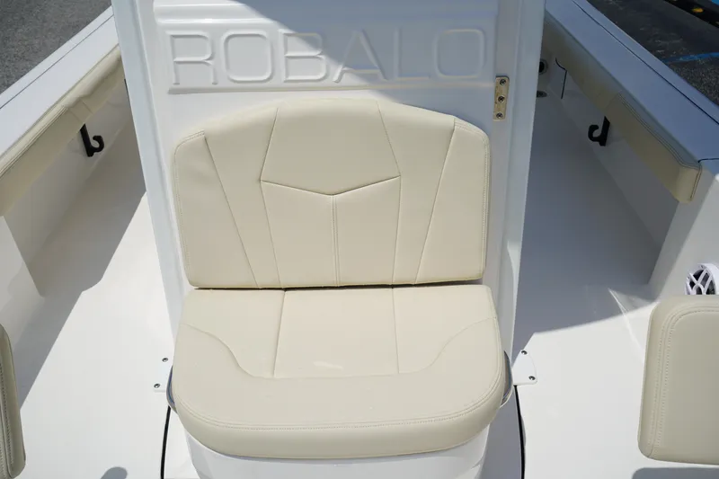 Slide: The Image of 2027 Robalo 226 Cayman boat seat with beige upholstery and embossed logo. - 15