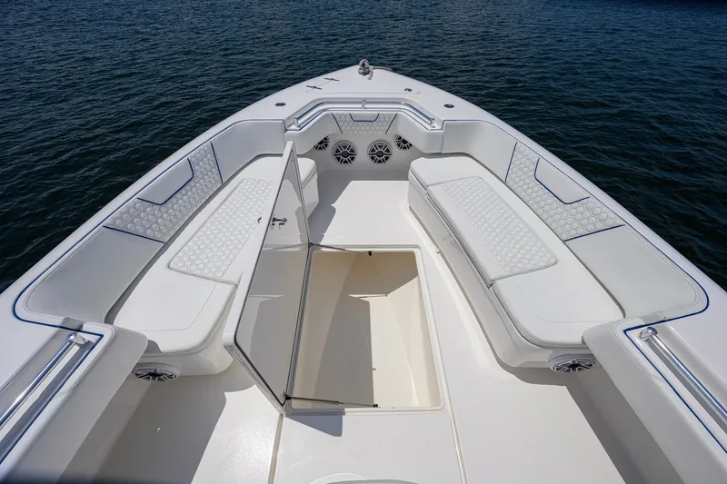 Slide: The Image of 2023 Contender 44 ST boat interior with white seating and open storage compartment. - 20