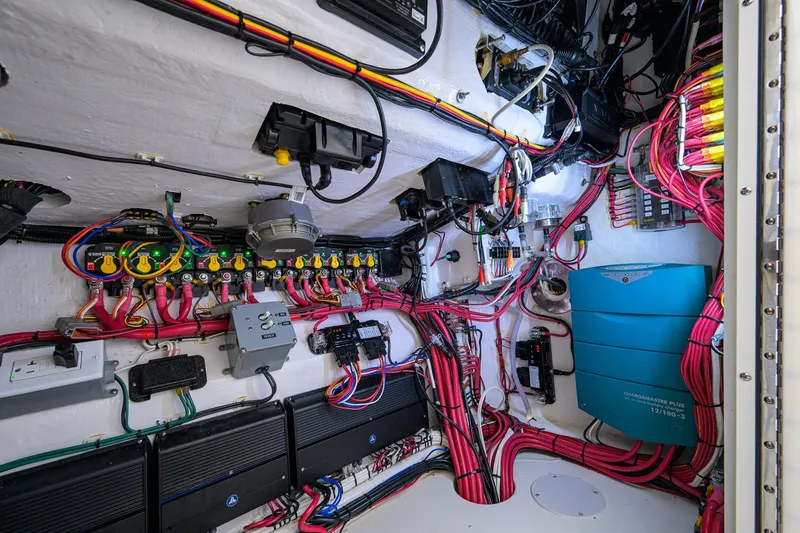 Slide: The Image of Electrical system inside 2023 Contender 44 ST boat, featuring organized wiring and components. - 68