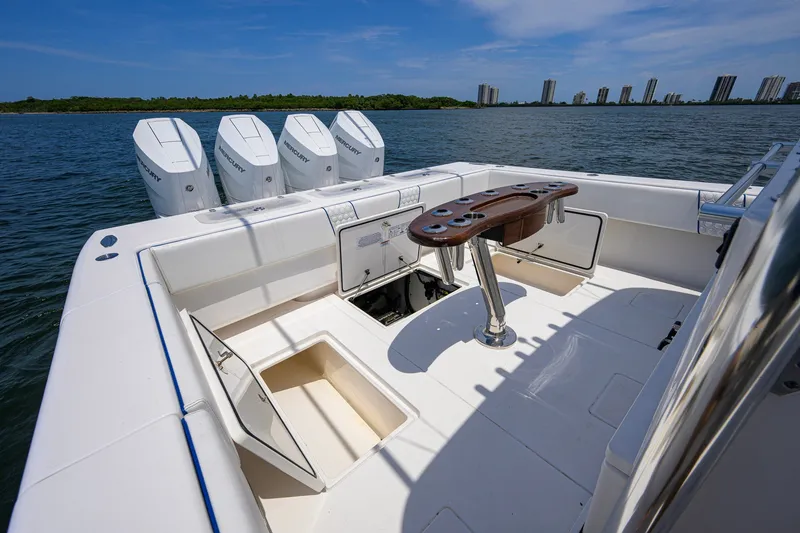 Slide: The Image of 2023 Contender 44 ST boat with quad Mercury engines, spacious deck, and fishing rod holders. - 60