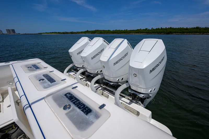 Slide: The Image of 2023 Contender 44 ST boat with four Mercury outboard engines on the water. - 54