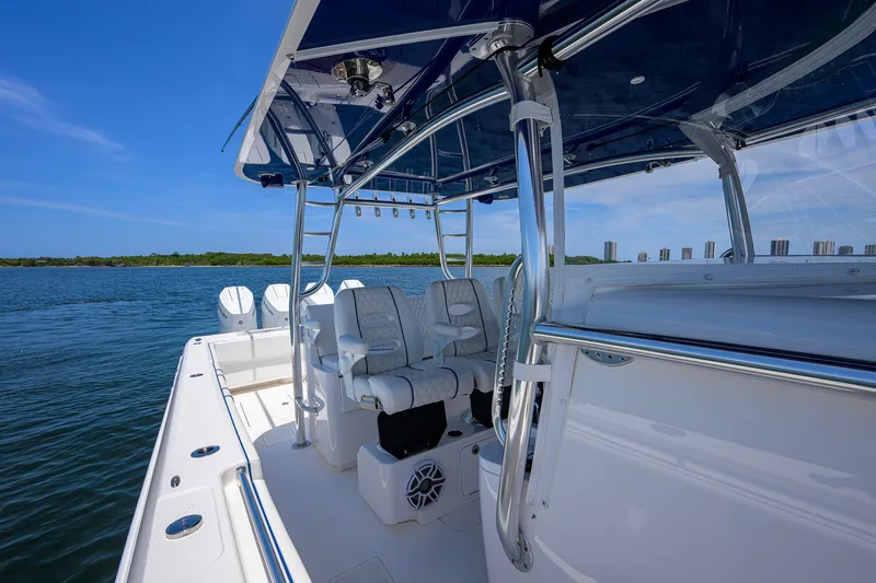 Slide: The Image of 2023 Contender 44 ST boat interior with seating, ocean view, and clear blue sky. - 33