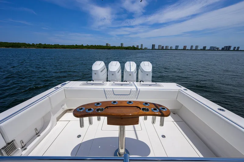 Slide: The Image of 2023 Contender 44 ST boat with quad engines on open water, city skyline in background. - 39