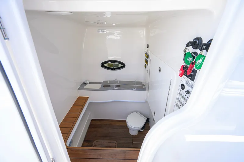 Slide: The Image of 2023 Contender 44 ST boat interior with wooden flooring and compact bathroom amenities. - 61