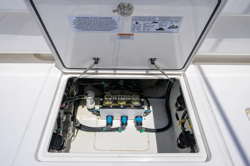 Slide: The Image of 2023 Contender 44 ST boat compartment with visible wiring and components. - 55