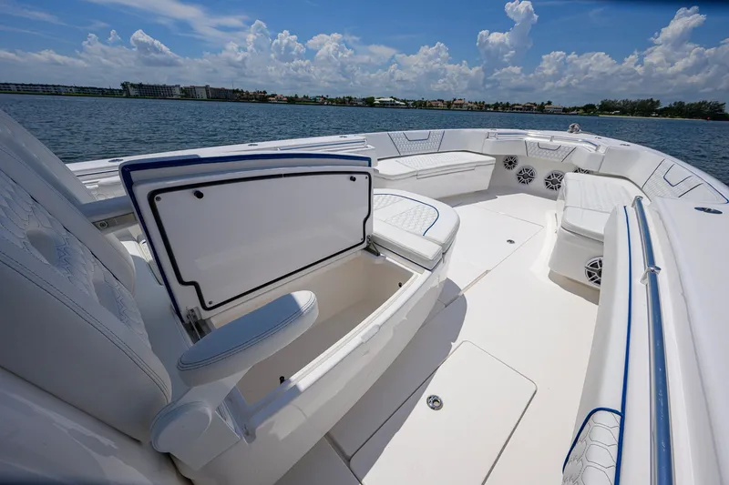 Slide: The Image of 2023 Contender 44 ST boat interior with open storage, white seating, and ocean view. - 27
